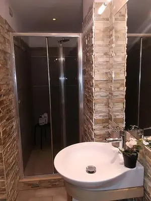 a bathroom with a white sink and a shower at HomeFlat in Rome