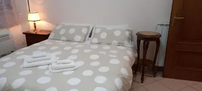 a bedroom with a polka dot bed with towels on it at ary's house in Rome