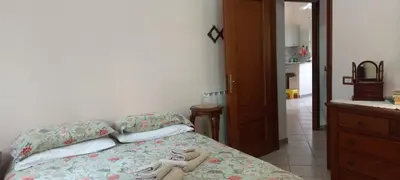 a bedroom with a bed with two pairs of shoes on it at ary's house in Rome