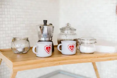 a wooden shelf with two cups and a blender on it at Cozy Penthouse with Terrace and Rome View in Rome