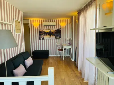 a living room with a couch and a table at Cozy Penthouse with Terrace and Rome View in Rome