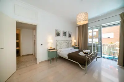 a bedroom with a bed and a table and a window at Bernadette Apartment - Vaticano area in Rome