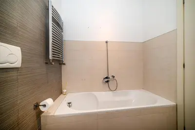 a white bath tub in a bathroom with a window at Bernadette Apartment - Vaticano area in Rome