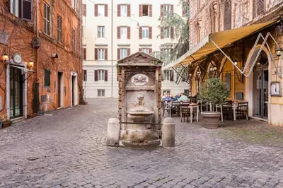 a clock in the middle of a street at Minisuite a Borgo Pio 