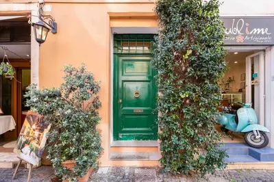 a green door on a building with a scooter at Minisuite a Borgo Pio 