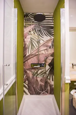 a shower in a bathroom with green walls at Hold Rome - Luxury Suites in Rome