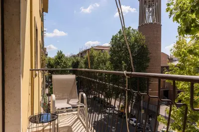 a balcony with a table and chairs on a building at La Dolce Vita - Trastevere Station in Rome