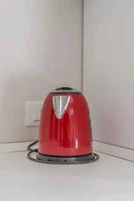 a red toaster sitting on top of a stove at La Dolce Vita - Trastevere Station in Rome