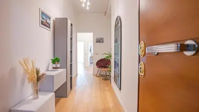 a hallway with a door and a room with a chair at Casa Bonnet - Elegant Stay near Trastevere & Gianicolo in Rome