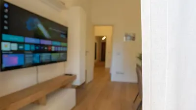 a living room with a flat screen tv on a wall at Casa Bonnet - Elegant Stay near Trastevere & Gianicolo in Rome