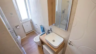 a bathroom with a sink and a toilet and a shower at Casa Bonnet - Elegant Stay near Trastevere & Gianicolo in Rome