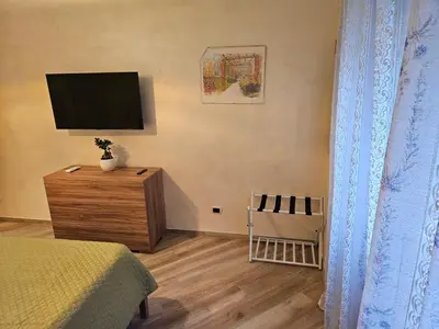a bedroom with a bed and a tv on the wall at Mary House in Rome