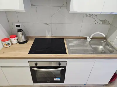 a kitchen counter with a stove and a sink at Mary House in Rome