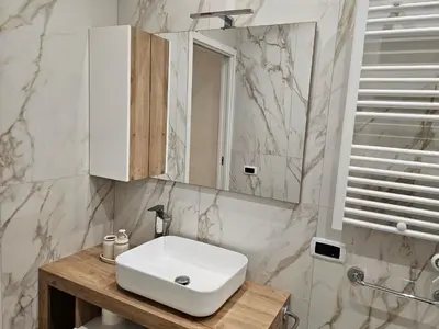 a bathroom with a white sink and a mirror at Mary House in Rome