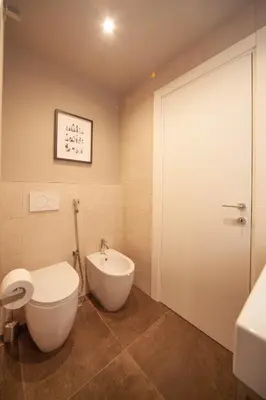 a bathroom with a toilet and a bidet at Luxury apartment with Vatican views in Rome