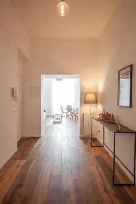 an empty living room with a table and a lamp at Luxury apartment with Vatican views in Rome