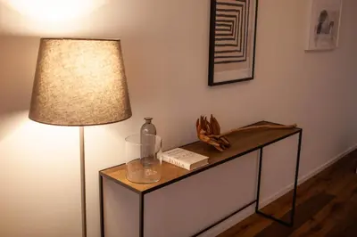 a table with a lamp and a bottle on it at Luxury apartment with Vatican views in Rome