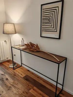 a desk in a room with a lamp and a wall at Luxury apartment with Vatican views in Rome