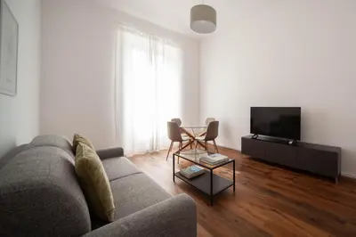 a living room with a couch and a tv at Luxury apartment with Vatican views in Rome