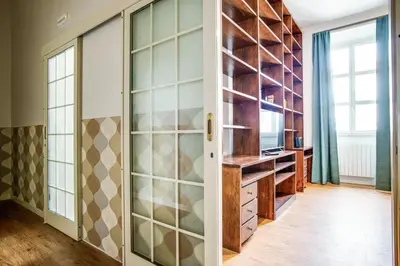 a home office with glass doors and a desk at Lovely Apartment in Rome - Volturno in Rome