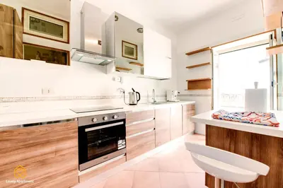a kitchen with white counters and a stove top oven at Lovely Apartment in Rome - Volturno in Rome