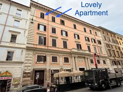 a large building on a street with a blue arrow at Lovely Apartment in Rome - Volturno in Rome
