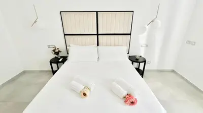 a bedroom with a white bed with two towels on it at Centro Solferino Rooms in Rome