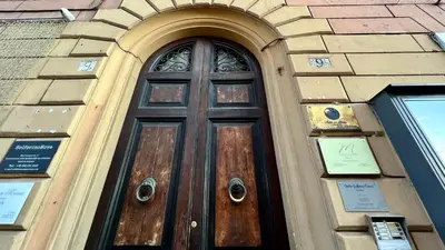 a wooden door in a building with a window at Centro Solferino Rooms in Rome