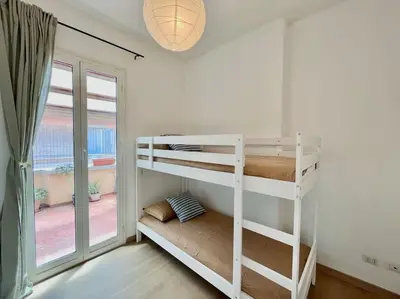 a white bunk bed in a room with a window at Roma San Pietro rooftop view in Rome