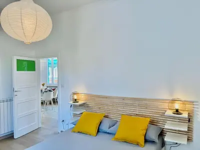 a bedroom with a large bed with yellow pillows at Roma San Pietro rooftop view in Rome
