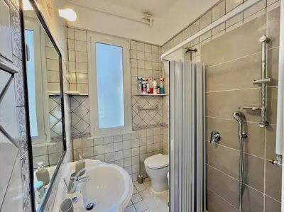 a bathroom with a sink and a toilet and a shower at Roma San Pietro rooftop view in Rome