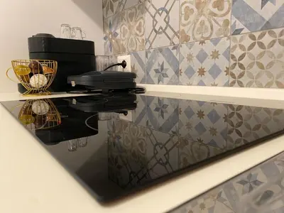 a mirror of a kitchen with a coffee maker on a table at Dany & Manu House in Rome