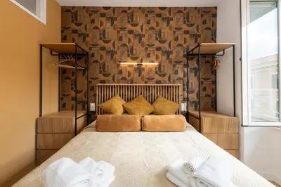 a bedroom with a large bed with pillows on it at Sistine Chapel View Rooms Check-in From 3 Pm To 10 Pm in Rome