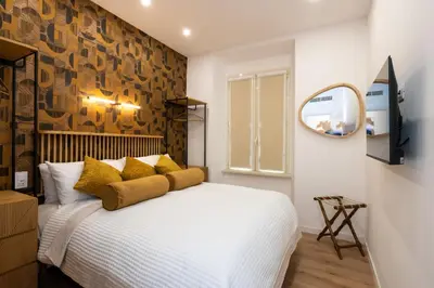 a bedroom with a white bed with yellow pillows at Sistine Chapel View Rooms Check-in From 3 Pm To 10 Pm in Rome