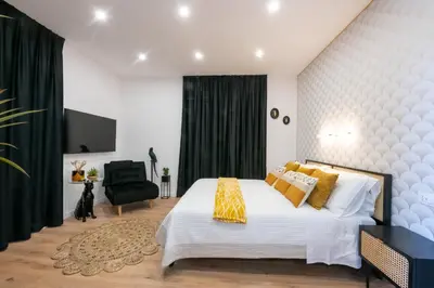 a bedroom with a large white bed and a black chair at Sistine Chapel View Rooms Check-in From 3 Pm To 10 Pm in Rome
