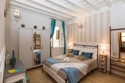 a bedroom with a bed and a desk at Boutique Domus Navona Librari in Rome