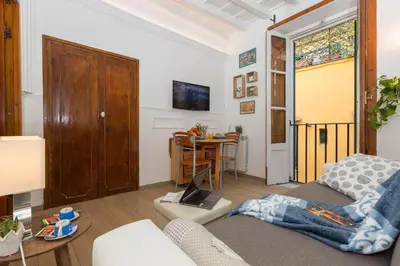 a living room with a couch and a table with a laptop at Boutique Domus Navona Librari in Rome