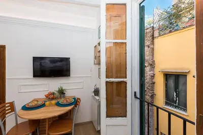 a small dining room with a table and a television at Boutique Domus Navona Librari in Rome