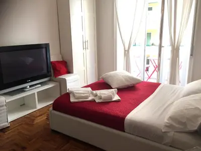 a bedroom with a bed with a tv and towels at Casa Volver in Rome