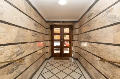 a hallway with wooden walls and a door at Casa Volver in Rome