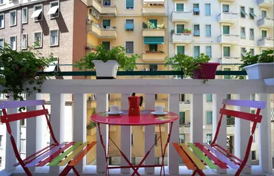 a red table and two chairs on a balcony at Casa Volver in Rome