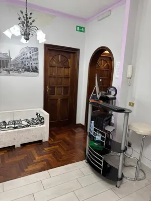 a room with a desk with a computer on a cart at Destination In Rome in Rome