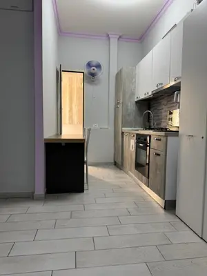 a kitchen with white cabinets and a tile floor at Destination In Rome in Rome