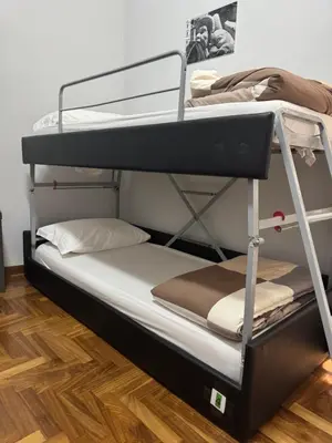 two bunk beds in a room with a wooden floor at Destination In Rome in Rome