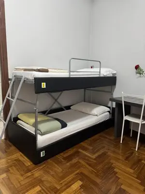 two bunk beds in a room with a table at Destination In Rome in Rome