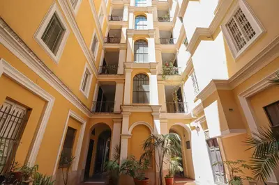 a building with balconies and plants in a courtyard at Essenza House Piazza Fiume in Rome