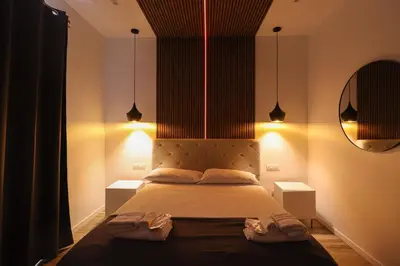 a bedroom with a large bed with two night stands at Essenza House Piazza Fiume in Rome