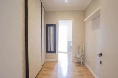 a hallway with a door and a chair in a room at Bright and Lovely Apartment in San Lorenzo in Rome