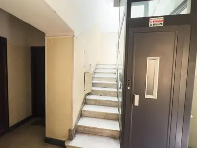 a stairway in a building with a door and stairs at Bright and Lovely Apartment in San Lorenzo in Rome