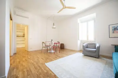 a living room with a table and a chair at Bright and Lovely Apartment in San Lorenzo in Rome